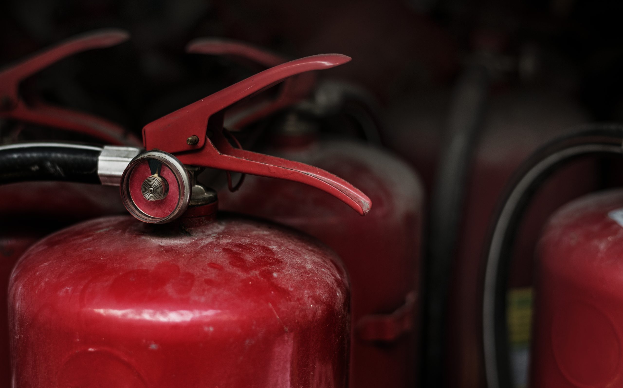 closeup red fire extinguishers scaled