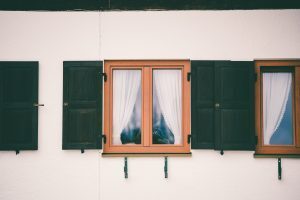 glass window with wooden frame white curtain inside