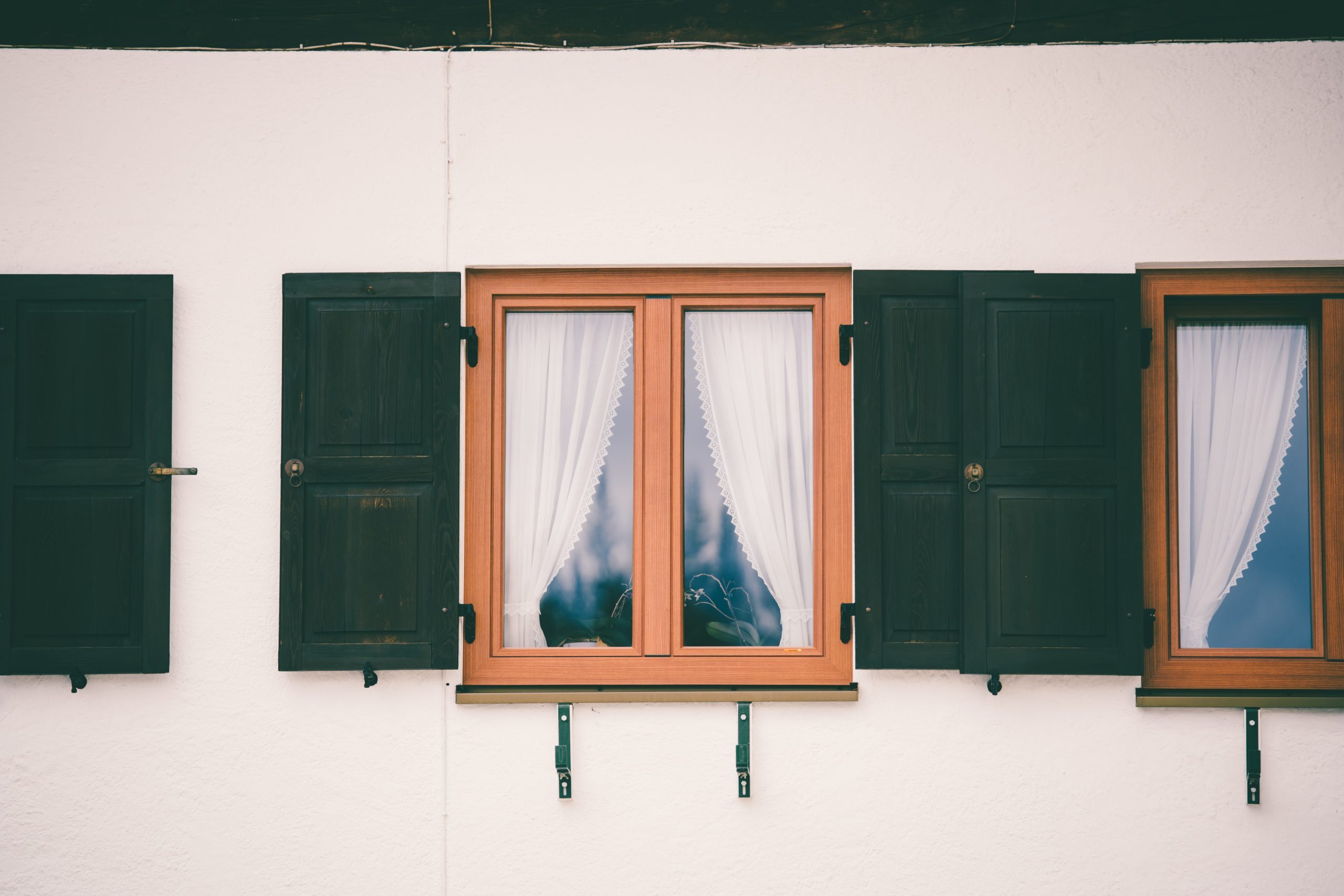 glass window with wooden frame white curtain inside scaled