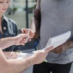 man giving paper sign