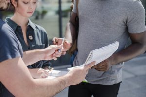man giving paper sign